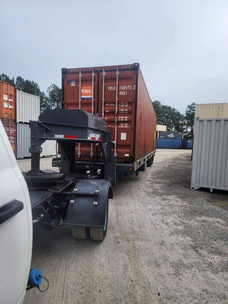 red shipping container on trailer.